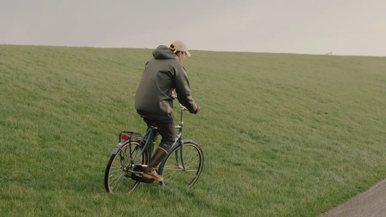 Fietser op een groene dijk
