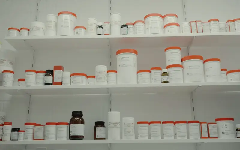 Schap met medicijnpotjes in een apotheek